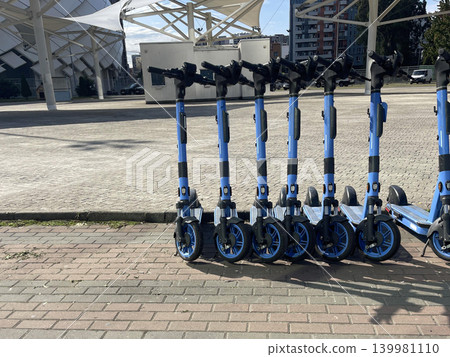 scooter on the city road for rent. concept city transport system scooter on the city road for rent. concept city transport system 139981110