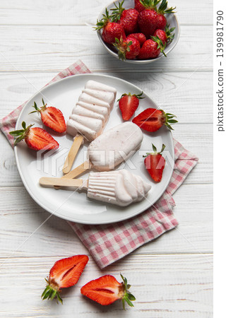 Homemade strawberry ice cream popsicles with fresh fruit Homemade strawberry ice cream popsicles with fresh fruit 139981790