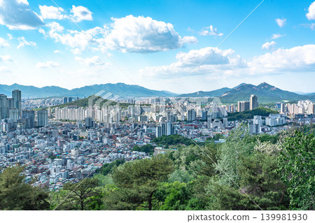 Seoul, South Korea - May. 08, 2026 : Panoramic view of the vast Seoul cityscape, Han River, and fluffy clouds under a clear blue spring sky from Yongmasan Mountain Seoul, South Korea - May. 08, 2026 : Panoramic view of the vast Seoul cityscape, Han River, and fluffy clouds under a clear blue spring sky from Yongmasan Mountain 139981930