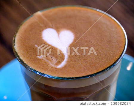 Heart Latte Art Coffee in the glass on blue plate 139982024