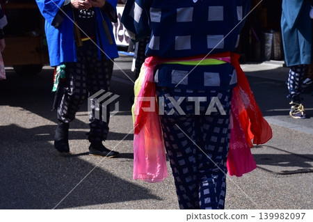 Men participating in the Inuyama Spring Festival in Inuyama City, Aichi Prefecture, are seen wearing traditional happi coats, straw sandals, and brightly colored obi belts. 139982097