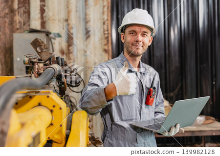 Portrait American Caucasian male worker happy smile working service machine in workshop with safety Portrait American Caucasian male worker happy smile working service machine in workshop with safety 139982128