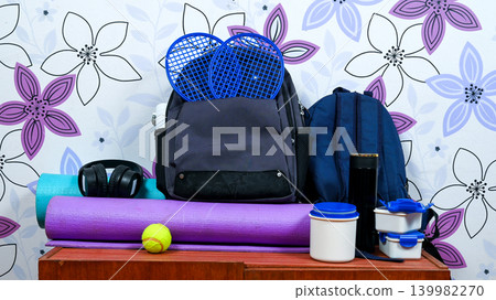 set of sports gear and backpacks on a wooden surface 139982270