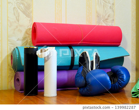 boxing gloves and bottles against a background of mats boxing gloves and bottles against a background of mats 139982287