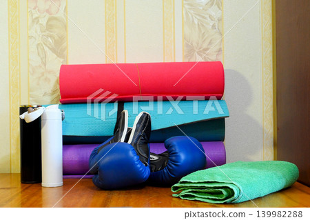 blue boxing gloves and mats on the table blue boxing gloves and mats on the table 139982288