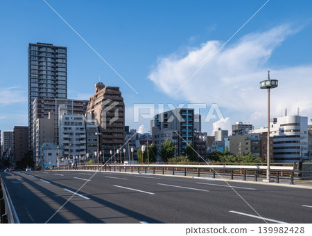 The architectural beauty of a massive bridge soaring dramatically against the blue sky. The architectural beauty of a massive bridge soaring dramatically against the blue sky. 139982428