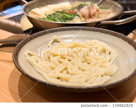Motsunabe is a Japanese hot pot dish. It's a miso-based hot pot dish with beef offal, chives, and tofu as ingredients. Udon noodles are added at the end. Motsunabe is a Japanese hot pot dish. It's a miso-based hot pot dish with beef offal, chives, and tofu as ingredients. Udon noodles are added at the end. 139982829