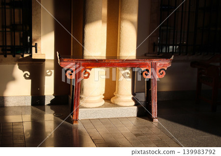 An old wooden table near marble columns An old wooden table near marble columns 139983792