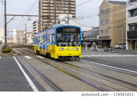 A Hankai Tramway streetcar travels along the main street (Daido-suji/Old Kishu Kaido) in the central area of Sakai City, Osaka Prefecture (Sakai Ward, Sakai City, Osaka Prefecture). A Hankai Tramway streetcar travels along the main street (Daido-suji/Old Kishu Kaido) in the central area of Sakai City, Osaka Prefecture (Sakai Ward, Sakai City, Osaka Prefecture). 139983852