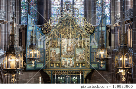 The Lady Chapel Altarpiece of Liverpool Cathedral features a breathtaking, intricately carved Gothic Revival triptych reredos. This highly ornate, gilded altarpiece is framed by sweeping blue shutters The Lady Chapel Altarpiece of Liverpool Cathedral features a breathtaking, intricately carved Gothic Revival triptych reredos. This highly ornate, gilded altarpiece is framed by sweeping blue shutters 139983900