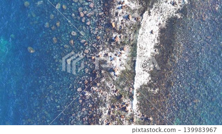 A drone aerial view of a beautiful rocky area with whitecaps. A drone aerial view of a beautiful rocky area with whitecaps. 139983967
