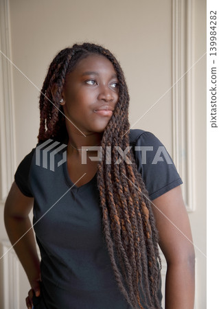 Confident young African woman portrait indoors, elegant lifestyle pose Confident young African woman portrait indoors, elegant lifestyle pose 139984282