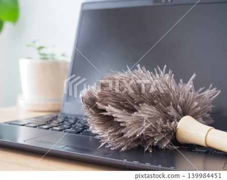 Clean your laptop with a duster. Clean your laptop with a duster. 139984451