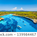 Aerial view of a sea bay and azure water in Mallorca, Spain. Scenic coastline landscape with boats 139984467
