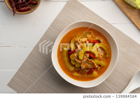 Thai Pork Curry with Bitter Gourd in white bowl. Thai Pork Curry with Bitter Gourd in white bowl. 139984584