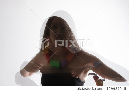 Woman with colorful necklace creating double exposure effect Woman with colorful necklace creating double exposure effect 139984646
