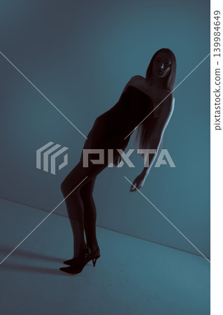 Woman model posing in mysterious blue lighting concept Woman model posing in mysterious blue lighting concept 139984649