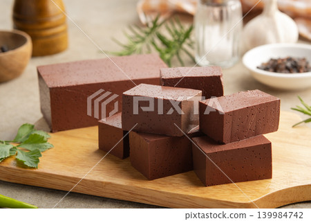 Sliced duck blood curd on wooden plate. 139984742