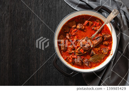 Beef goulash stew with paprika in ceramic pot Beef goulash stew with paprika in ceramic pot 139985429