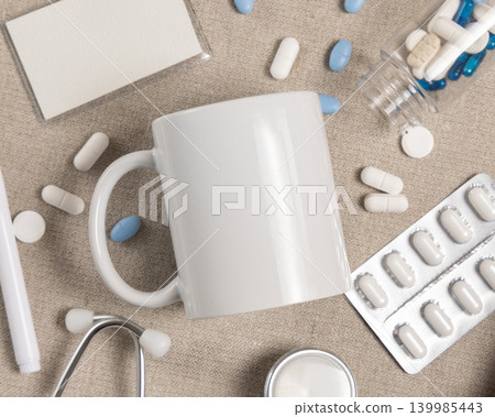 White 11 oz coffee mug mockup with medical accessories and pills top view, blank template White 11 oz coffee mug mockup with medical accessories and pills top view, blank template 139985443