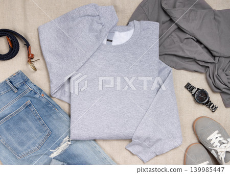 Blank greyunisex sweatshirt mockup, folded crewneck flat lay with denim jeans and mens accessories Blank greyunisex sweatshirt mockup, folded crewneck flat lay with denim jeans and mens accessories 139985447