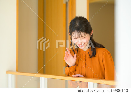 Japanese woman looking down from the connecting corridor Japanese woman looking down from the connecting corridor 139986140