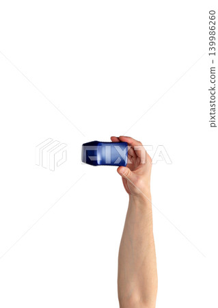 male hand raised up holding a blue bottle on a white background 139986260