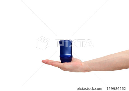 blue bottle standing on an open male palm on a white background blue bottle standing on an open male palm on a white background 139986262