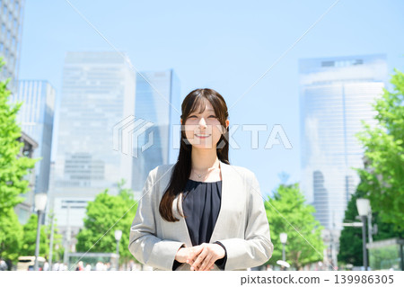 Japanese woman standing in a city of skyscrapers Japanese woman standing in a city of skyscrapers 139986305