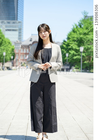 Japanese woman standing in a city of skyscrapers Japanese woman standing in a city of skyscrapers 139986306