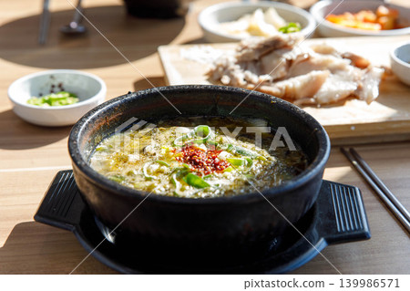 Traditional Jeju Pork and Seaweed Soup Momguk in Earthenware Pot Traditional Jeju Pork and Seaweed Soup Momguk in Earthenware Pot 139986571