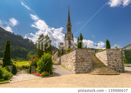 Church with stone staircase in Lungern Switzerland on sunny day Church with stone staircase in Lungern Switzerland on sunny day 139986637