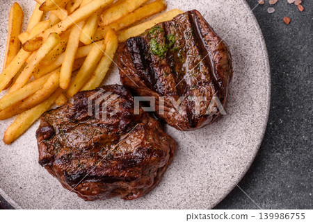 Beef mignon steak, rare, meat grilled with salt and spices. Beef steak Beef mignon steak, rare, meat grilled with salt and spices. Beef steak 139986755