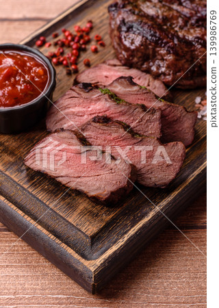 Beef mignon steak, rare, meat grilled with salt and spices. Beef steak Beef mignon steak, rare, meat grilled with salt and spices. Beef steak 139986769