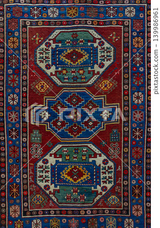 Authentic traditional Borchaly carpet from the Kazakh group of Azerbaijan featuring bold geometric ornaments, rich woven texture, and colorful Caucasian ethnic craftsmanship. Decorative oriental rug Authentic traditional Borchaly carpet from the Kazakh group of Azerbaijan featuring bold geometric ornaments, rich woven texture, and colorful Caucasian ethnic craftsmanship. Decorative oriental rug 139986961