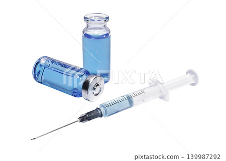 Medical vials with blue vaccine and syringe on a white background Medical vials with blue vaccine and syringe on a white background 139987292