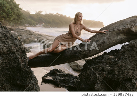 Stylish blonde woman posing on tropical beach Stylish blonde woman posing on tropical beach 139987482