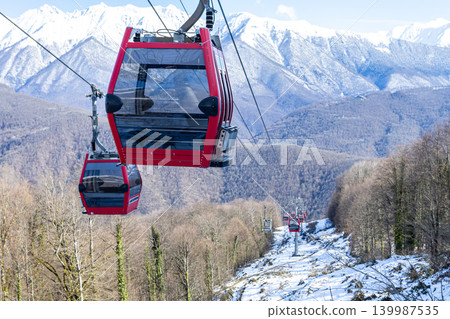 Gondola lift against the backdrop of snow-capped mountains 139987535