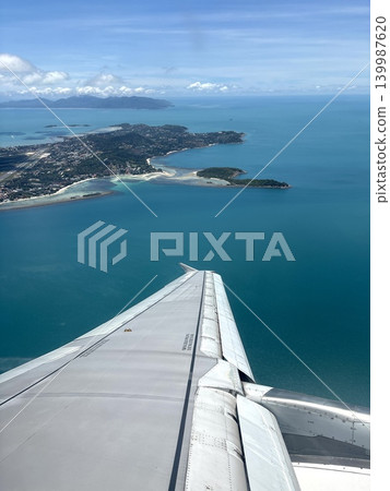 A view of a flight to a tropical paradise from an airplane. A view of a flight to a tropical paradise from an airplane. 139987620