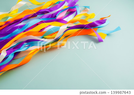 Colorful Rainbow Ribbon Wand with Wooden Sticks on Light Blue Background 139987643