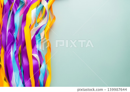 Colorful Rainbow Ribbon Wand with Wooden Sticks on Light Blue Background 139987644