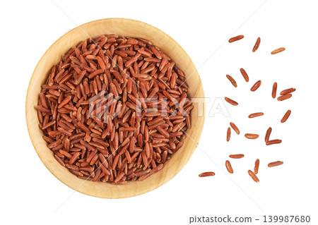 red rice in a wooden bowl isolated on white background. Top view. Flat lay red rice in a wooden bowl isolated on white background. Top view. Flat lay 139987680
