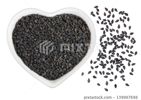 black sesame seeds in ceramic bowl isolated on white background. Top view. Flat lay black sesame seeds in ceramic bowl isolated on white background. Top view. Flat lay 139987698