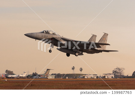 A Japan Air Self-Defense Force F-15DJ Eagle takes off in the winter morning light. A Japan Air Self-Defense Force F-15DJ Eagle takes off in the winter morning light. 139987763