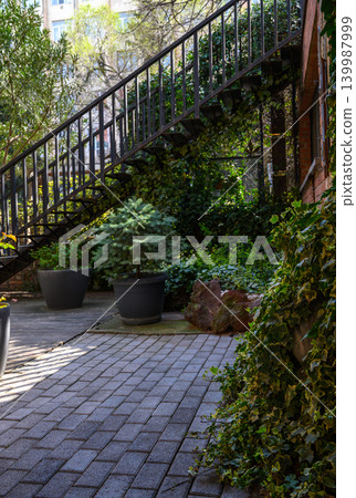 Sunlit narrow alley with brick buildings, Tbilisi 139987999