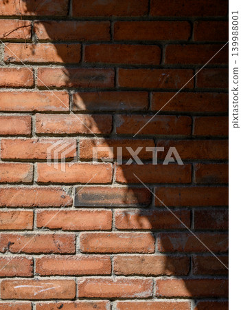 Old brick wall with diagonal sunlight and shadow Old brick wall with diagonal sunlight and shadow 139988001