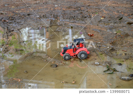 Toy tractor in mud close-up Toy tractor in mud close-up 139988071