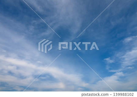 Expansive blue sky adorned with wispy clouds on a tranquil day 139988102