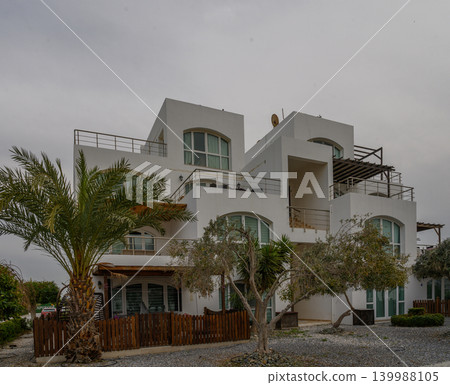 Modern architecture blends with nature in serene coastal retreat near the beach Modern architecture blends with nature in serene coastal retreat near the beach 139988105
