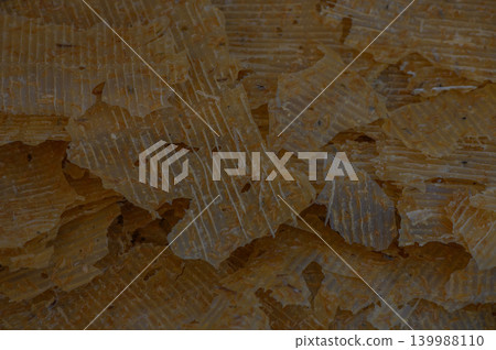 Natural wax flakes scattered on a smooth surface, showcasing their textural beauty and warm hue in a cozy setting Natural wax flakes scattered on a smooth surface, showcasing their textural beauty and warm hue in a cozy setting 139988110